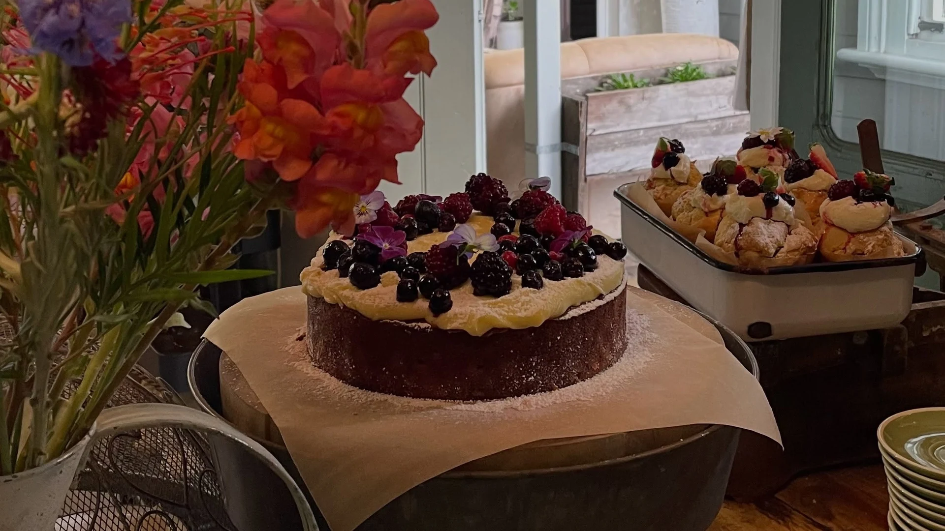 House-baked cakes and treats at the café beside fresh flowers